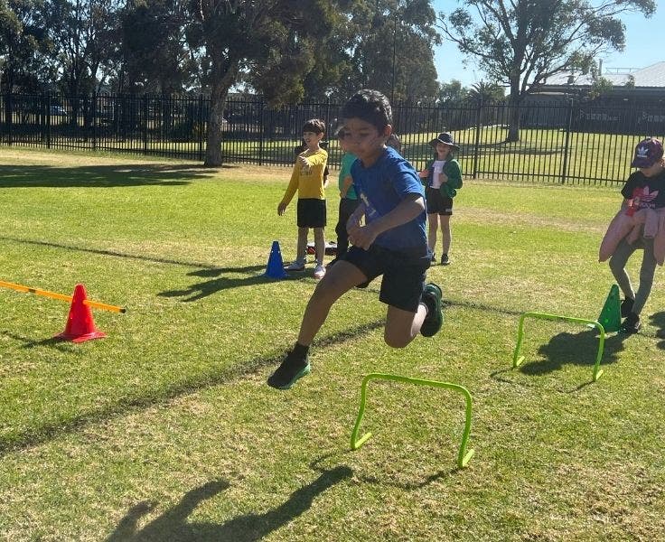 Student jumping hurdles as part of athletics carnival.