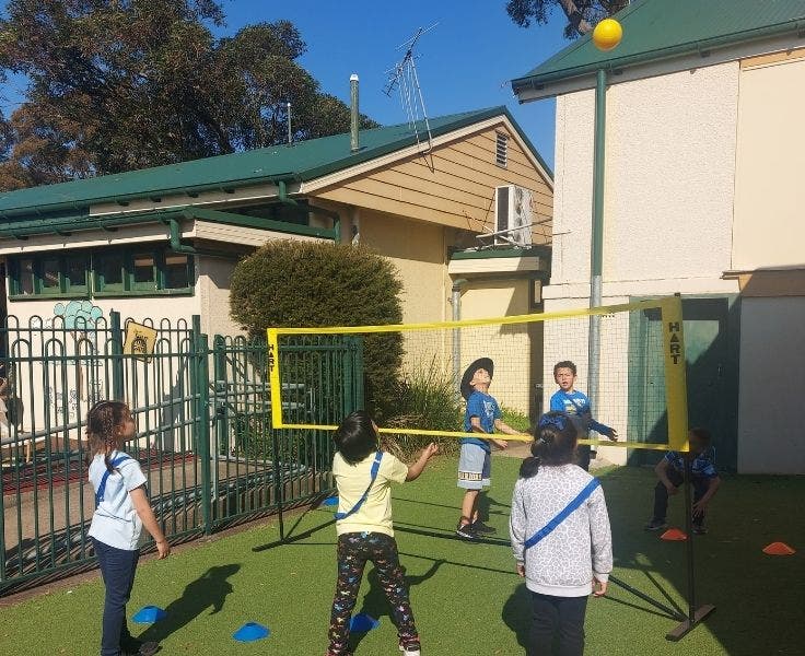 Six students playing modified volleyball.