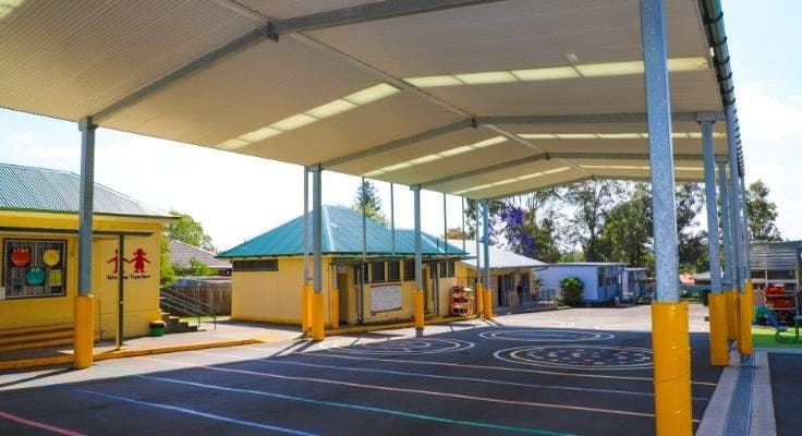 Outdoor playground with large covered outdoor learning area (COLA).